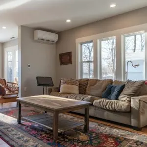 An indoor ductless mini-split heat pump providing quiet and efficient heating in a living room.