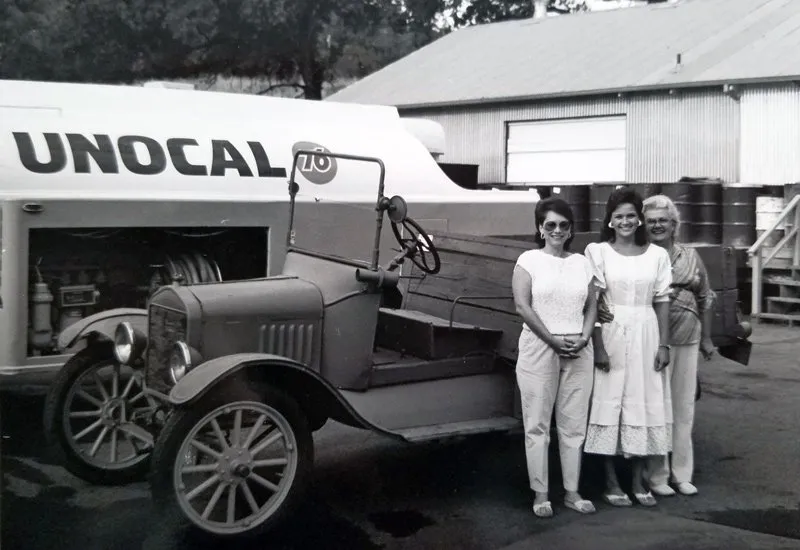 A historic photo of the Jonas Energy Solutions team standing beside a vintage UNOCAL truck